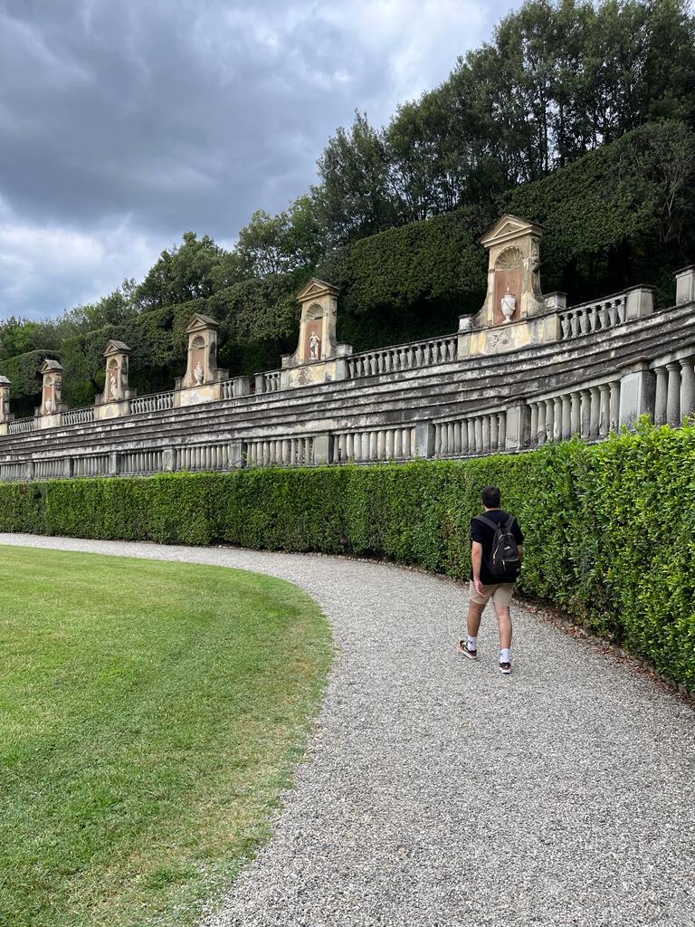 Okan walking through a garden in Europe